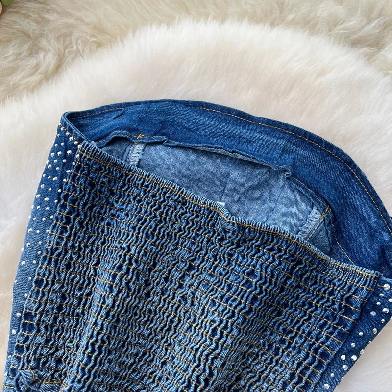 A stylish women’s summer outfit featuring a versatile sleeveless strapless vest with rhinestones and high-waisted denim trumpet pants.