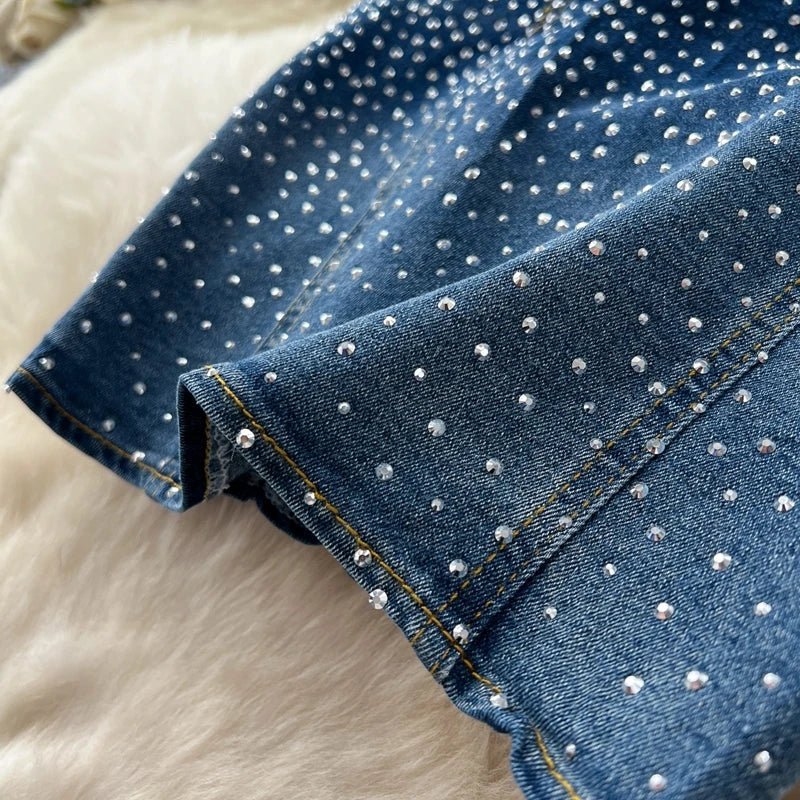 A stylish women’s summer outfit featuring a versatile sleeveless strapless vest with rhinestones and high-waisted denim trumpet pants.