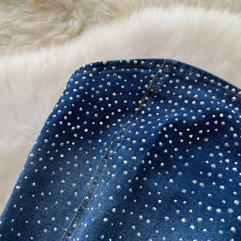 A stylish women’s summer outfit featuring a versatile sleeveless strapless vest with rhinestones and high-waisted denim trumpet pants.