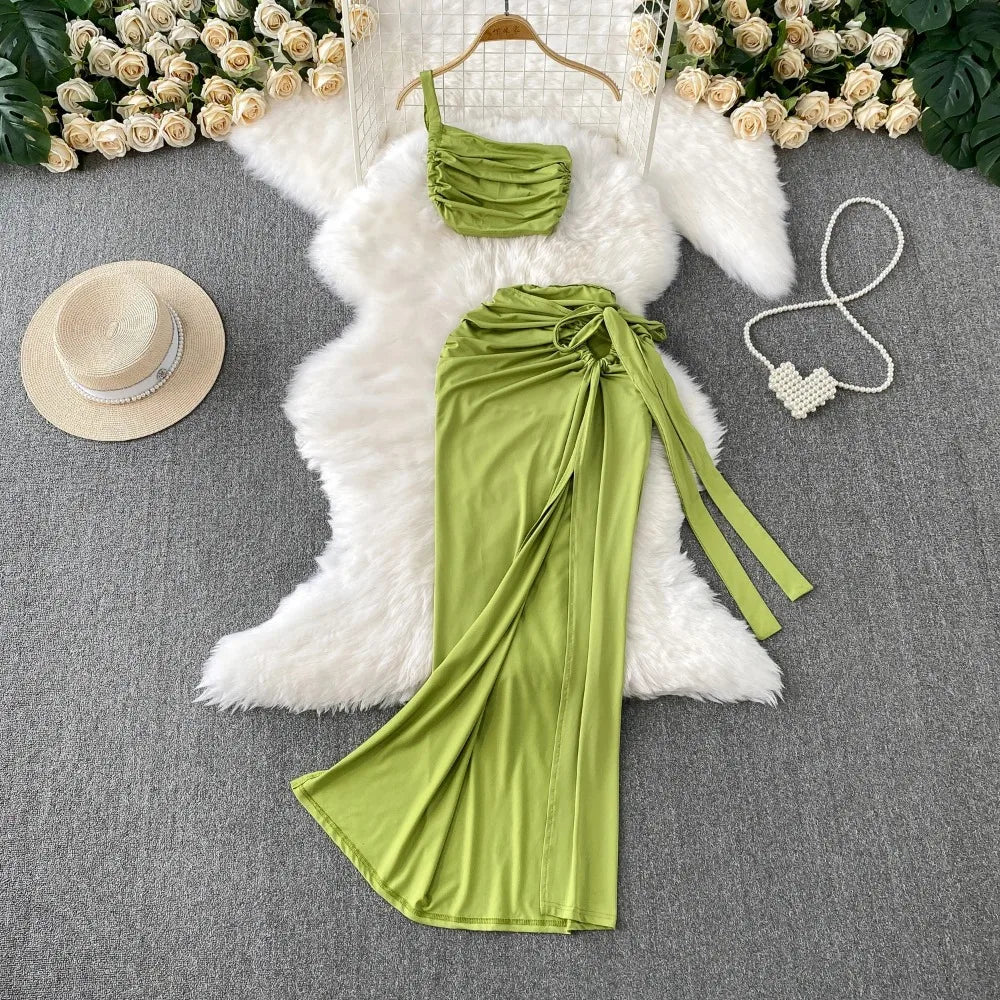 A stylish two-piece set of a split hollow-out slim slip dress and a casual beach party-ready vintage dress, perfect for women’s summer fashion.