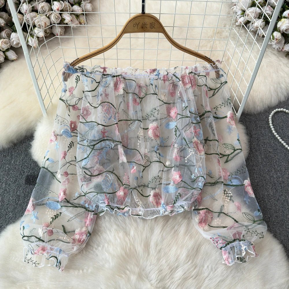 A women’s tulle blouse with a floral embroidery design, long puff sleeves, and a loose fit - MODE SEPHRA