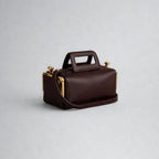 A luxurious designer bag for women with a two-sided clamp frame and a kiss lock.