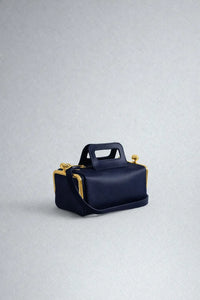 A luxurious designer bag for women with a two-sided clamp frame and a kiss lock.