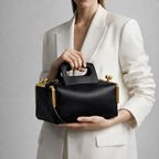 A luxurious designer bag for women with a two-sided clamp frame and a kiss lock.
