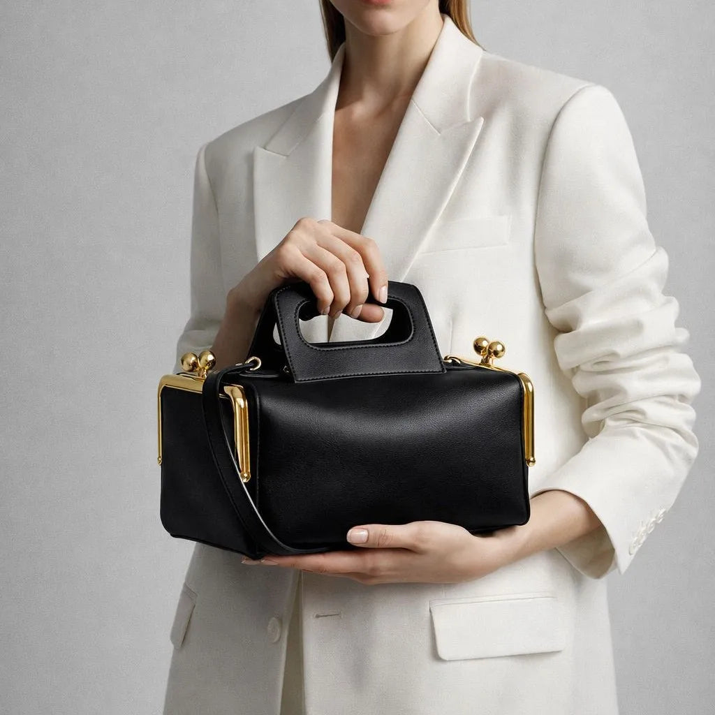 A luxurious designer bag for women with a two-sided clamp frame and a kiss lock.