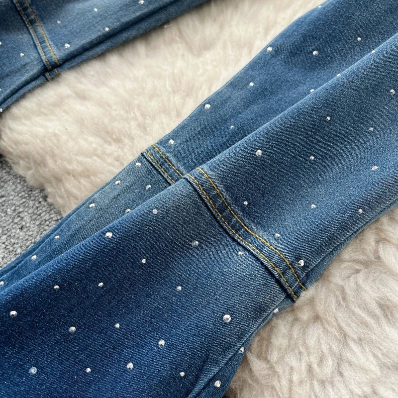 A stylish women’s summer outfit featuring a versatile sleeveless strapless vest with rhinestones and high-waisted denim trumpet pants.